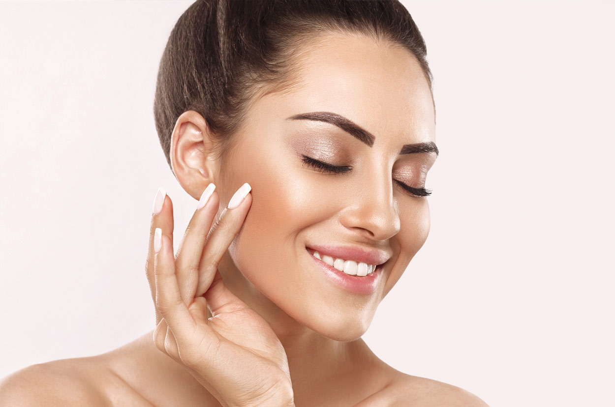Portrait of woman with beauty face and perfect skin on beige background. Skin care. Cosmetology, beauty and spa.